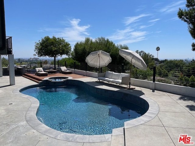 view of pool with a patio area and an in ground hot tub