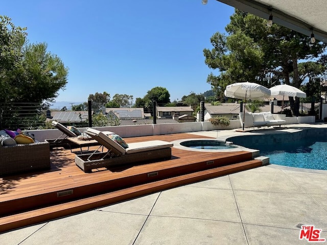 view of pool featuring a deck, a patio, and an in ground hot tub