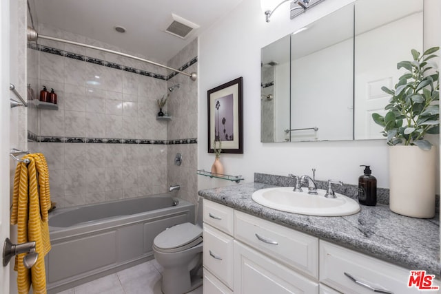 full bathroom featuring tiled shower / bath combo, vanity, toilet, and tile patterned flooring