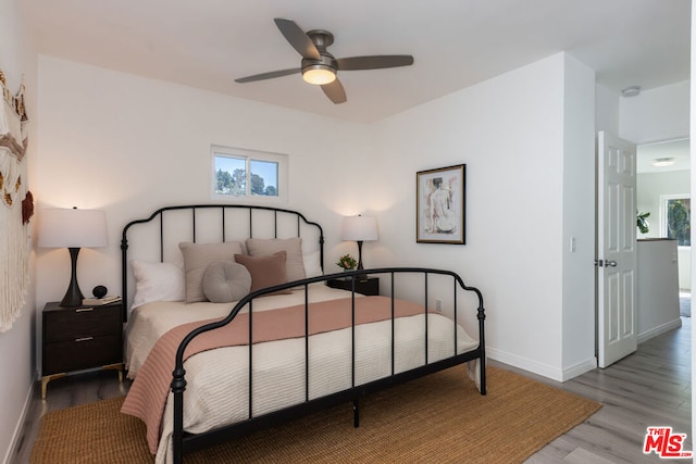 bedroom with ceiling fan and light hardwood / wood-style floors