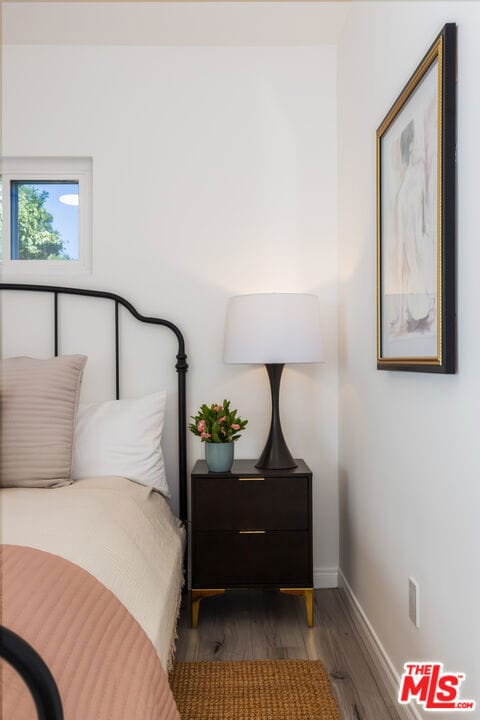 bedroom with dark hardwood / wood-style floors