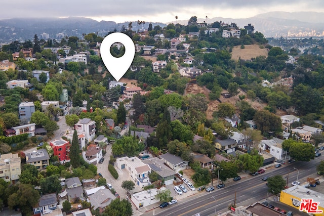 birds eye view of property with a mountain view