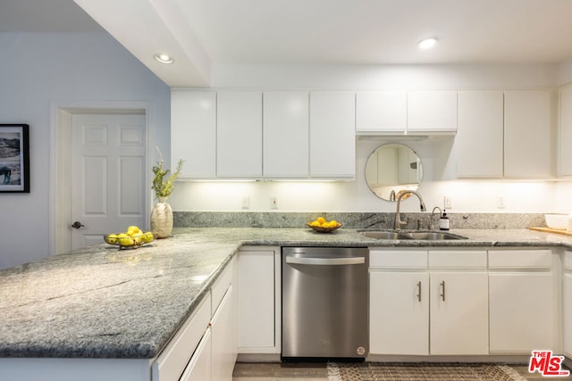 kitchen featuring stainless steel dishwasher, white cabinets, and sink