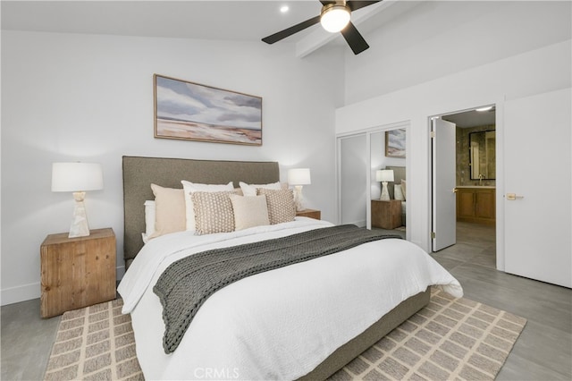 bedroom with ceiling fan, ensuite bath, vaulted ceiling, and a closet