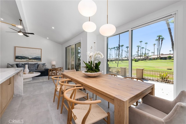 dining room with ceiling fan and vaulted ceiling