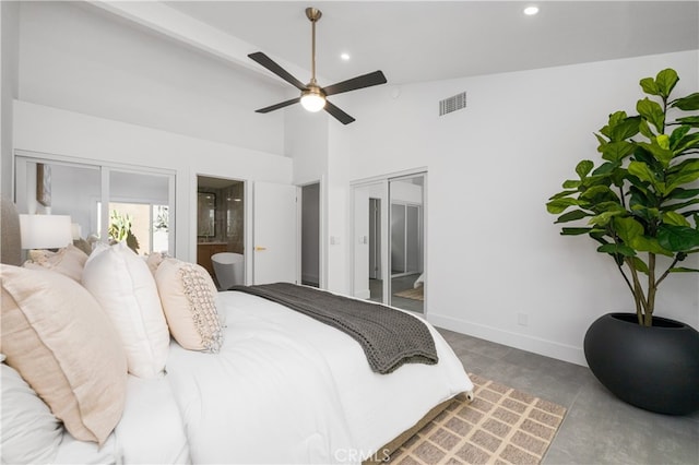 bedroom with ceiling fan, connected bathroom, and lofted ceiling