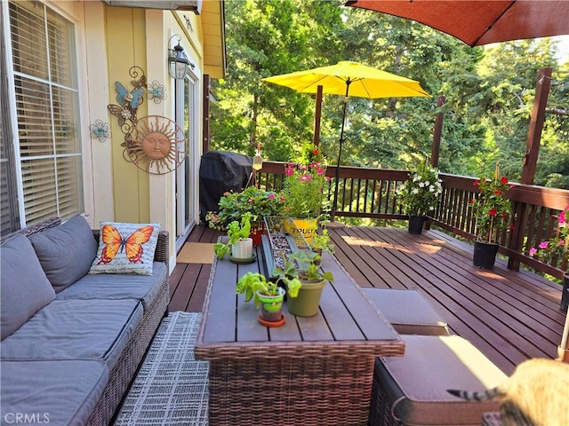 deck with a grill and outdoor lounge area