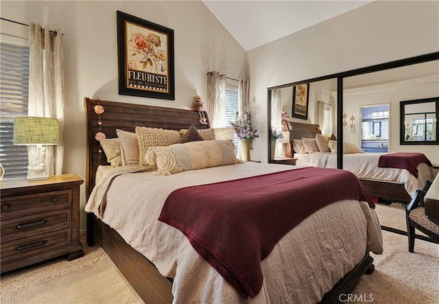 bedroom featuring light carpet and lofted ceiling