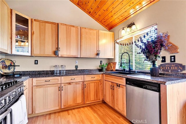 kitchen with appliances with stainless steel finishes, lofted ceiling, light hardwood / wood-style floors, sink, and light brown cabinetry