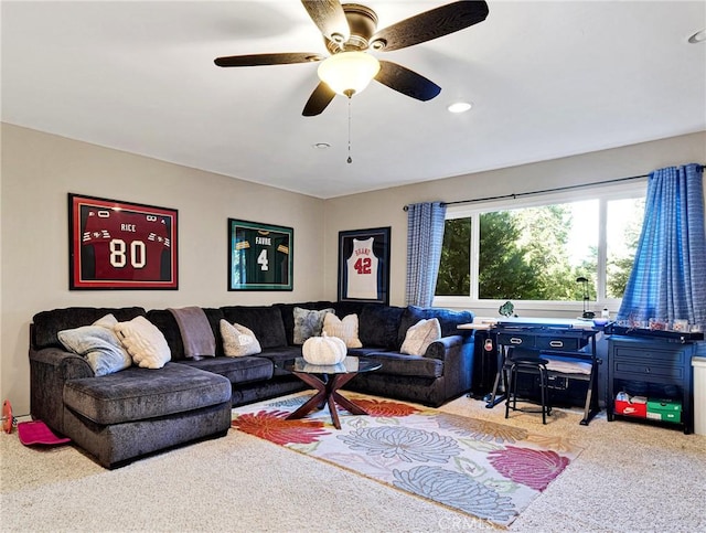 carpeted living room with ceiling fan