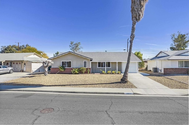 view of front of home with a garage and cooling unit