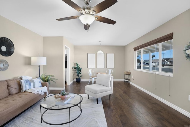 living room featuring ceiling fan and dark hardwood / wood-style floors