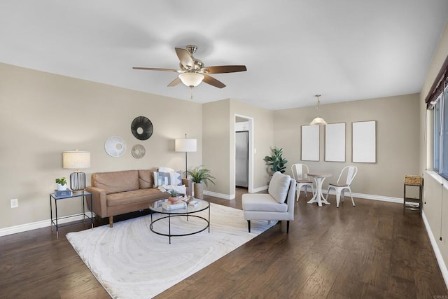 living room with ceiling fan and dark hardwood / wood-style floors