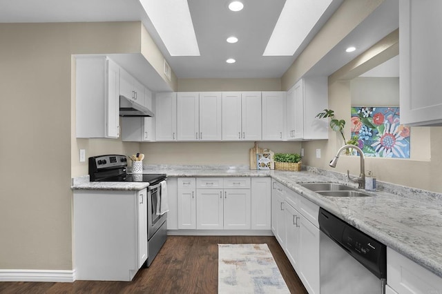 kitchen featuring sink, stainless steel appliances, a skylight, and white cabinetry