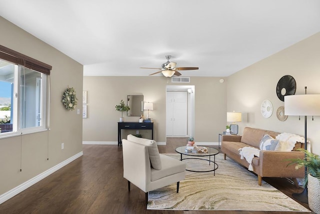 living room featuring dark wood-type flooring and ceiling fan