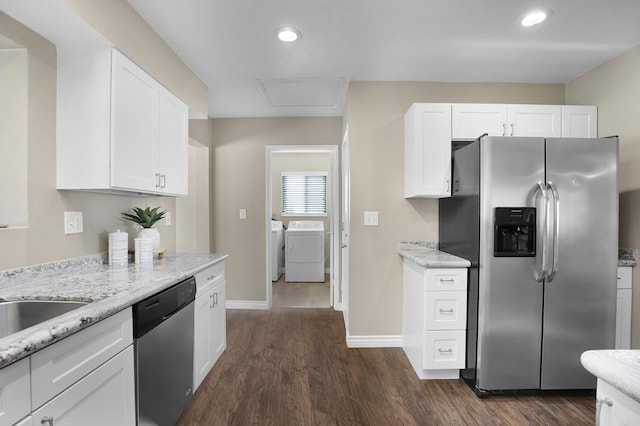 kitchen featuring white cabinets, stainless steel appliances, dark hardwood / wood-style flooring, and separate washer and dryer