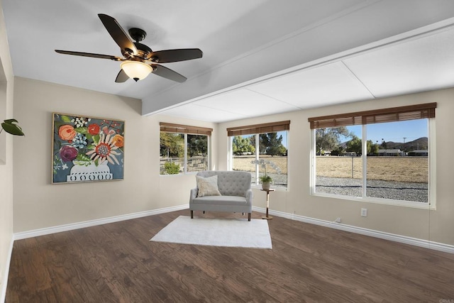 unfurnished room featuring ceiling fan, beam ceiling, and dark wood-type flooring