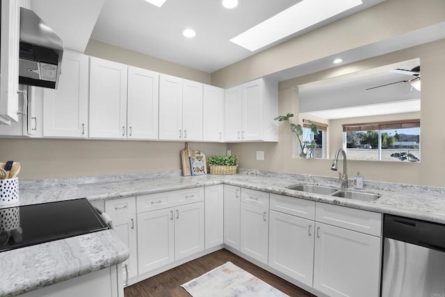 kitchen featuring sink, white cabinets, stainless steel dishwasher, a skylight, and dark hardwood / wood-style flooring