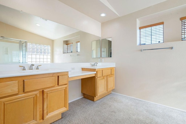 bathroom with lofted ceiling and vanity