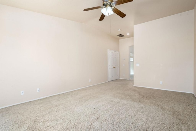 carpeted empty room featuring ceiling fan and vaulted ceiling