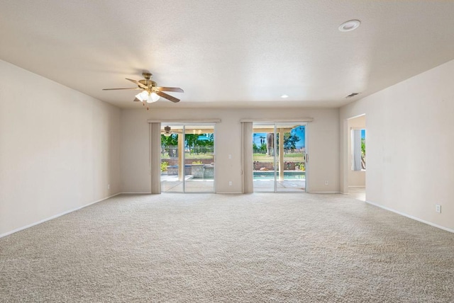 spare room featuring ceiling fan and carpet floors