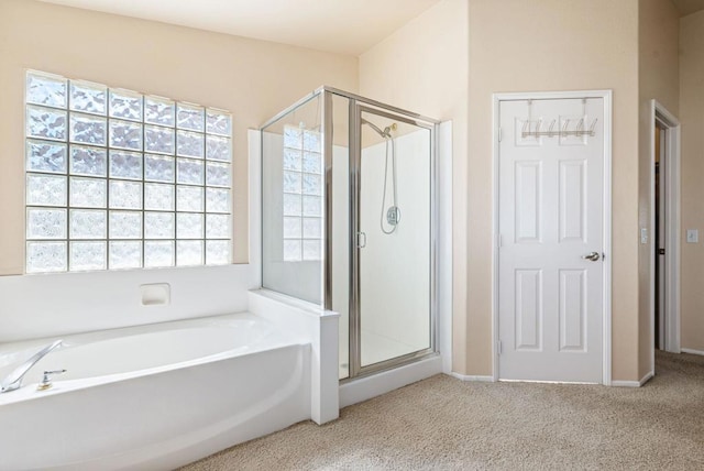 bathroom featuring independent shower and bath