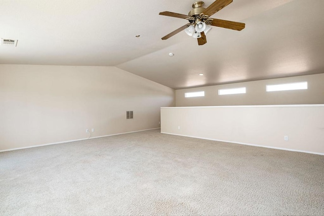 carpeted empty room featuring lofted ceiling and ceiling fan