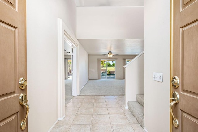 entrance foyer with light carpet and ceiling fan