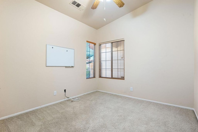 empty room featuring ceiling fan, light carpet, and lofted ceiling