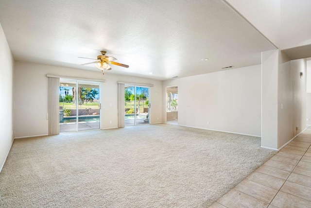 carpeted empty room with ceiling fan