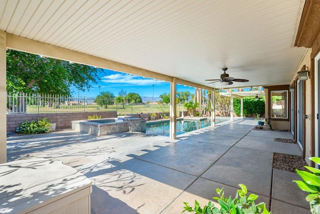 view of patio with ceiling fan and a swimming pool with hot tub