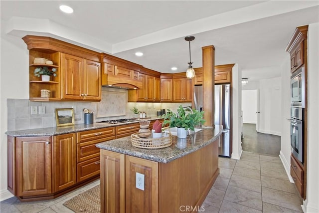 kitchen with stainless steel appliances, decorative backsplash, decorative light fixtures, dark stone counters, and a kitchen island