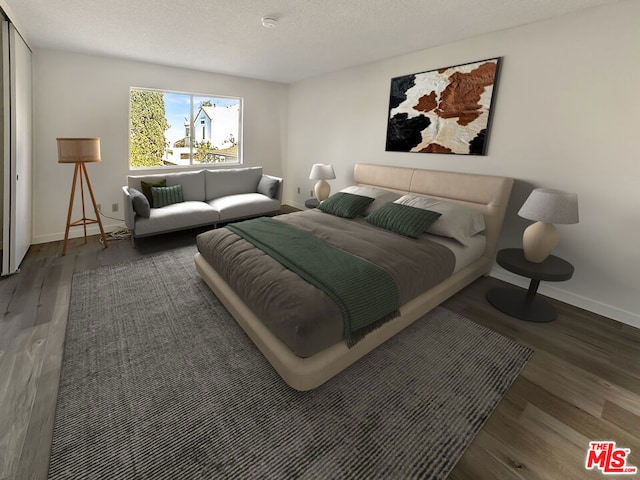 bedroom featuring a textured ceiling and dark hardwood / wood-style floors