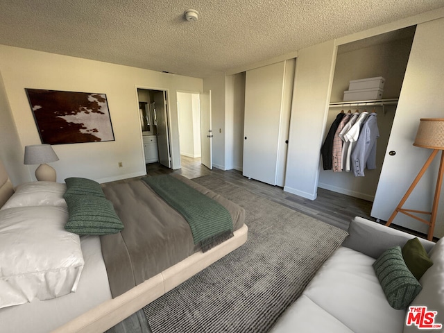 bedroom featuring a textured ceiling, dark hardwood / wood-style floors, and a closet