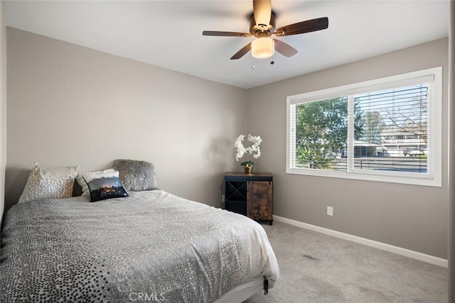 bedroom featuring ceiling fan and light carpet