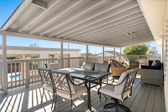 deck with outdoor dining space, an outdoor living space, and a fenced in pool