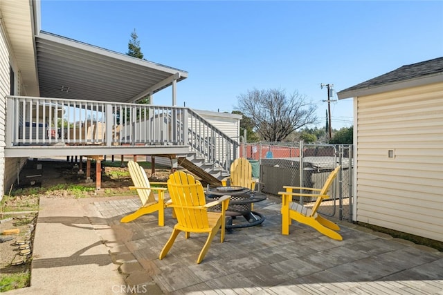 view of patio featuring stairway, a wooden deck, and fence