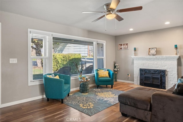 living room with ceiling fan and wood-type flooring