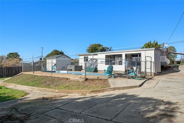 view of front of home featuring fence private yard and an outdoor structure