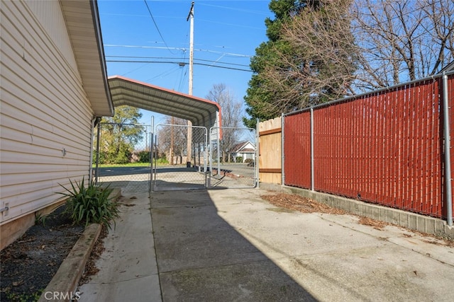 view of street with a gate, driveway, and a gated entry