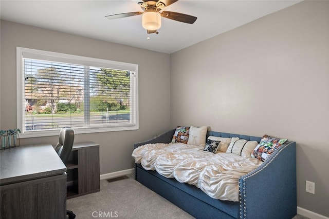 carpeted bedroom with visible vents, baseboards, and ceiling fan