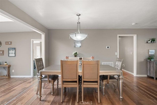 dining room featuring dark wood-type flooring