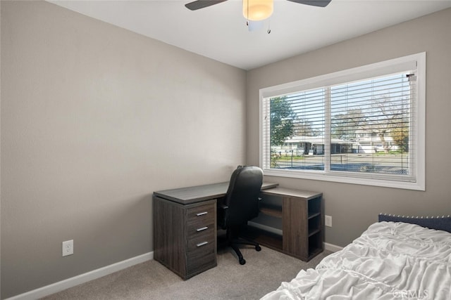 bedroom featuring baseboards, light carpet, and a ceiling fan