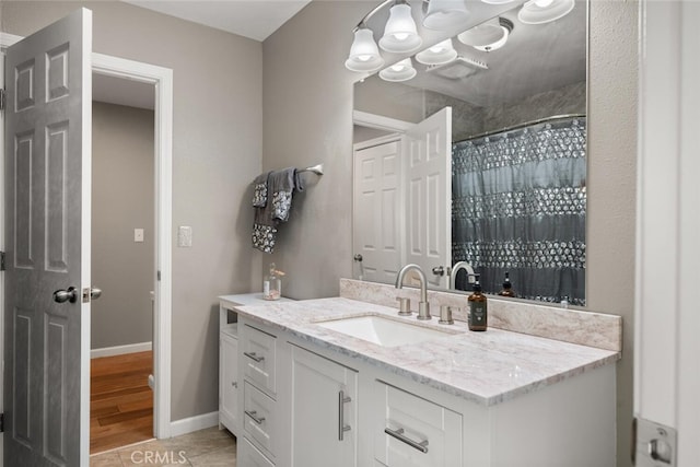 full bath with curtained shower, baseboards, wood finished floors, and vanity