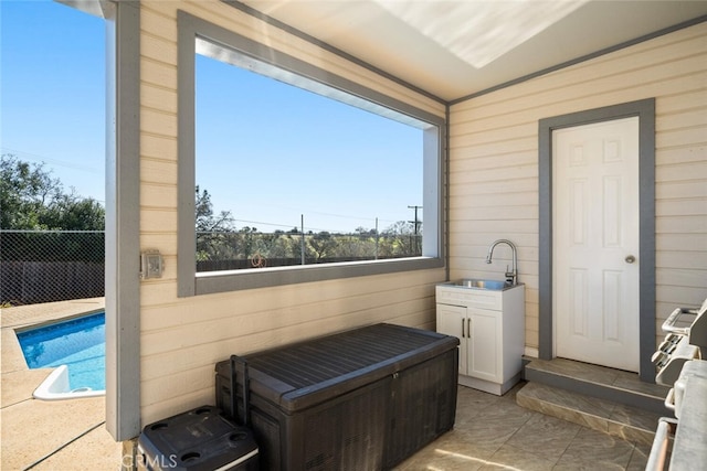 bathroom with wooden walls and a sink