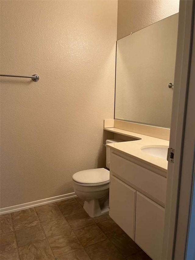 bathroom with toilet and vanity