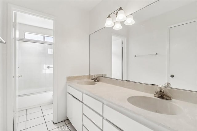 bathroom featuring tile patterned floors, enclosed tub / shower combo, and vanity