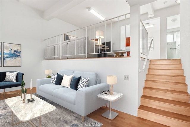 living room with hardwood / wood-style floors and beamed ceiling