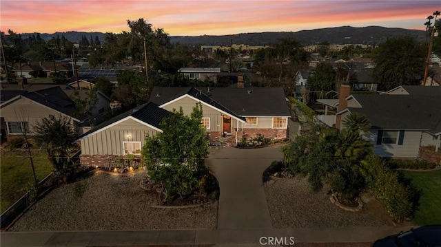 aerial view at dusk featuring a mountain view