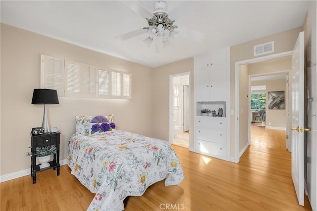 bedroom with ceiling fan and wood-type flooring